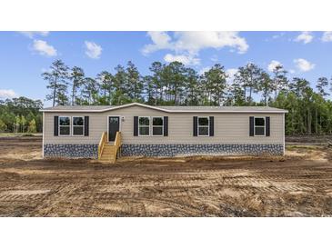 Inviting exterior view of the single story home, complete with a wood staircase and stone skirting at 108 Forman Way, Aynor, SC 29511
