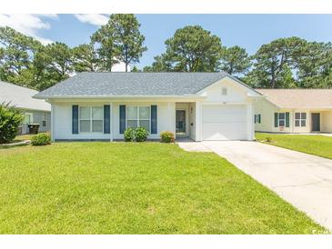 Charming single-story home featuring a well-manicured lawn and a classic white exterior at 123 Retreat Pl., Little River, SC 29566