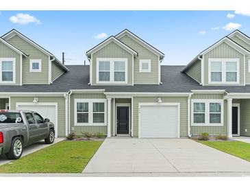 Charming townhome with a one car garage, black front door and muted green siding at 244 Jasper Overlook Way # 244, Myrtle Beach, SC 29588