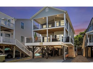 Two-story coastal home featuring dual balconies and covered parking at 6001-1010 S Kings Highway, Myrtle Beach, SC 29575