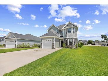 Charming two-story home features stone accents, a two-car garage, and a well-manicured lawn at 715 Hobonny Loop, Longs, SC 29568