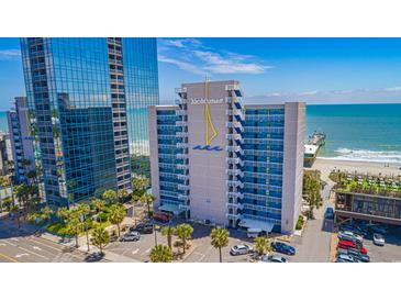 Bright exterior shot of The Yachtsman condo building with palm trees, blue skies, and ocean views at 1304 N Ocean Blvd. # 200, Myrtle Beach, SC 29577