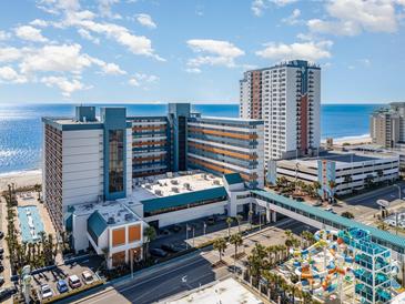 Stunning aerial view of the Landmark Resort featuring a beachfront location, pools, and modern architecture on a sunny day at 1501 S Ocean Blvd. # 945, Myrtle Beach, SC 29577