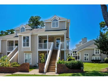 Charming townhouse with a welcoming entrance, staircase, and manicured landscaping at 3835 Masters Ct. # 135, Myrtle Beach, SC 29577
