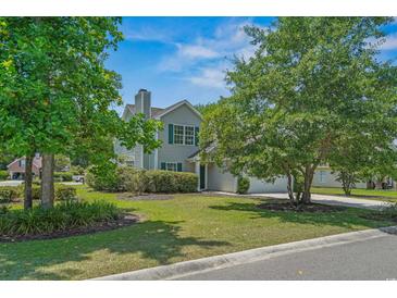 Charming two-story home with well-manicured lawn, lush landscaping, and attached garage at 4539 Fringetree Dr., Murrells Inlet, SC 29576