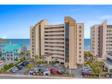Multi-story condo building features a parking lot, neutral tones, and coastal views at 517 S Ocean Blvd. # 705, North Myrtle Beach, SC 29582