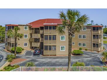Coastal condo building featuring multiple balconies and lush landscaping at 609 Hillside Dr. S # D-17, North Myrtle Beach, SC 29582