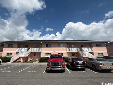 Well-maintained two-story condo building with ample parking and exterior staircases to upper units at 1101 2Nd Ave. N # 403, Surfside Beach, SC 29575