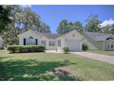Charming single-story home featuring a well-manicured lawn and inviting curb appeal on a sunny day at 23 Robert Conway Ct., Georgetown, SC 29440