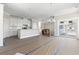 Open-concept living room with white kitchen, sliding glass door, and dining area at 112 Waterway Crossing Ct., Little River, SC 29566