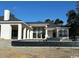 Rear exterior of a luxury home with covered patio and a pool at 4302 Gray Heron Dr., North Myrtle Beach, SC 29582