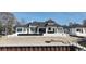 Rear exterior of a luxury home with covered patio and manicured landscape at 4302 Gray Heron Dr., North Myrtle Beach, SC 29582
