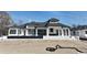 Rear exterior of a luxury home with covered patio and manicured landscape at 4302 Gray Heron Dr., North Myrtle Beach, SC 29582