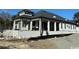 Rear exterior of a luxury home with covered patio supported by columns at 4302 Gray Heron Dr., North Myrtle Beach, SC 29582