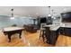 Spacious finished basement featuring a bar, pool table, stone fireplace, and a comfortable leather sofa at 1262 Limestone St., Murrells Inlet, SC 29576