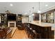 Basement bar with granite countertops, barstool seating, and dark wood cabinetry at 1262 Limestone St., Murrells Inlet, SC 29576