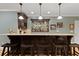 Basement bar with stone countertops, wood cabinets and storage for glasses and wine bottles at 1262 Limestone St., Murrells Inlet, SC 29576