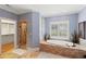 Stylish bathroom showcasing a soaking tub, glass-enclosed shower, and tile flooring at 1262 Limestone St., Murrells Inlet, SC 29576
