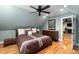 Cozy bedroom boasts wood floors, ceiling fan, comfortable bed, and a wooden dresser with mirror at 1262 Limestone St., Murrells Inlet, SC 29576