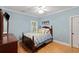 Cozy bedroom with light blue walls, wood floors, and a matching dresser at 1262 Limestone St., Murrells Inlet, SC 29576