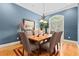 Inviting dining room with blue walls, hardwood floors, a decorative chandelier, and a large window at 1262 Limestone St., Murrells Inlet, SC 29576