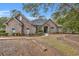 Charming brick home with arched windows, a manicured lawn, and mature trees creating curb appeal at 1262 Limestone St., Murrells Inlet, SC 29576