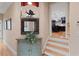 Inviting hallway with a decorative cabinet and mirror, leading to a modern kitchen at 1262 Limestone St., Murrells Inlet, SC 29576