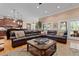 Open-concept living room featuring a large leather sectional, hardwood floors, and access to the kitchen at 1262 Limestone St., Murrells Inlet, SC 29576