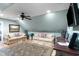 Comfortable living room featuring neutral tones, plush sofas, ceiling fan, and a large patterned rug at 1262 Limestone St., Murrells Inlet, SC 29576