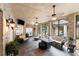 Comfortable sunroom featuring brick walls, tile flooring, ceiling fans, and cozy seating arrangements at 1262 Limestone St., Murrells Inlet, SC 29576