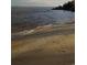 Sandy beach with gentle waves and footprints at 7101 Choppee Rd., Georgetown, SC 29440
