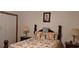 Bedroom with a floral comforter and wooden bed frame at 7101 Choppee Rd., Georgetown, SC 29440