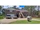 Brick house with a metal roof, double-car garage, and landscaping at 7101 Choppee Rd., Georgetown, SC 29440