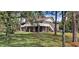 Two-story brick home with a deck and surrounding trees at 7101 Choppee Rd., Georgetown, SC 29440