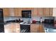 Kitchen features wood cabinets, built-in microwave, and stovetop at 7101 Choppee Rd., Georgetown, SC 29440