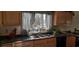 Kitchen with wood cabinets, double sink, and dark countertop at 7101 Choppee Rd., Georgetown, SC 29440