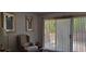 Living room features a wingback chair and access to a patio at 7101 Choppee Rd., Georgetown, SC 29440