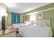 Comfortable bedroom with two beds, television, and bright wall color at 2301 S Ocean Blvd. # 621, Myrtle Beach, SC 29577