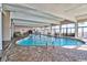 Large indoor pool with lounge chairs and tables, and surrounded by floor-to-ceiling windows at 2301 S Ocean Blvd. # 621, Myrtle Beach, SC 29577