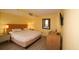 Comfortable bedroom with warm yellow walls, queen bed, dresser, and modern decor at 1501 S Ocean Blvd. # 1048, Myrtle Beach, SC 29577