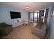 Inviting living room with comfortable seating, large TV, and balcony access at 1501 S Ocean Blvd. # 1048, Myrtle Beach, SC 29577
