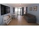 Bright living area featuring a dining set, gray sofa, and access to a balcony at 1501 S Ocean Blvd. # 1048, Myrtle Beach, SC 29577