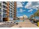 Inviting outdoor pool area with lounge chairs, palm trees, and partial ocean views at 1501 S Ocean Blvd. # 1048, Myrtle Beach, SC 29577