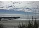 Ocean pier and beach view with blue skies at 9 Gumwood Dr., Carolina Shores, NC 28467