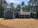 Newly built home with gray siding, red door and landscaped lawn at 9 Gumwood Dr., Carolina Shores, NC 28467