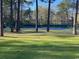 Tennis courts surrounded by lush trees at 9 Gumwood Dr., Carolina Shores, NC 28467