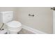 Close-up of a standard white toilet against a neutral wall with updated hardware at 546 Beckham Ct., Murrells Inlet, SC 29576