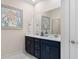 Double vanity bathroom with dark cabinets and white counters at 552 Beckham Ct., Murrells Inlet, SC 29576