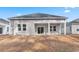 Gray house with covered patio and surrounding yard at 552 Beckham Ct., Murrells Inlet, SC 29576