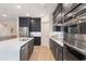 Modern kitchen with dark cabinets, stainless steel appliances and white quartz countertops at 552 Beckham Ct., Murrells Inlet, SC 29576